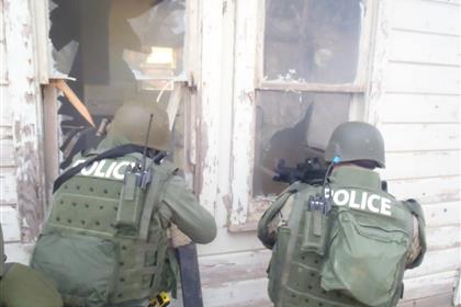 SWAT officers at broken window